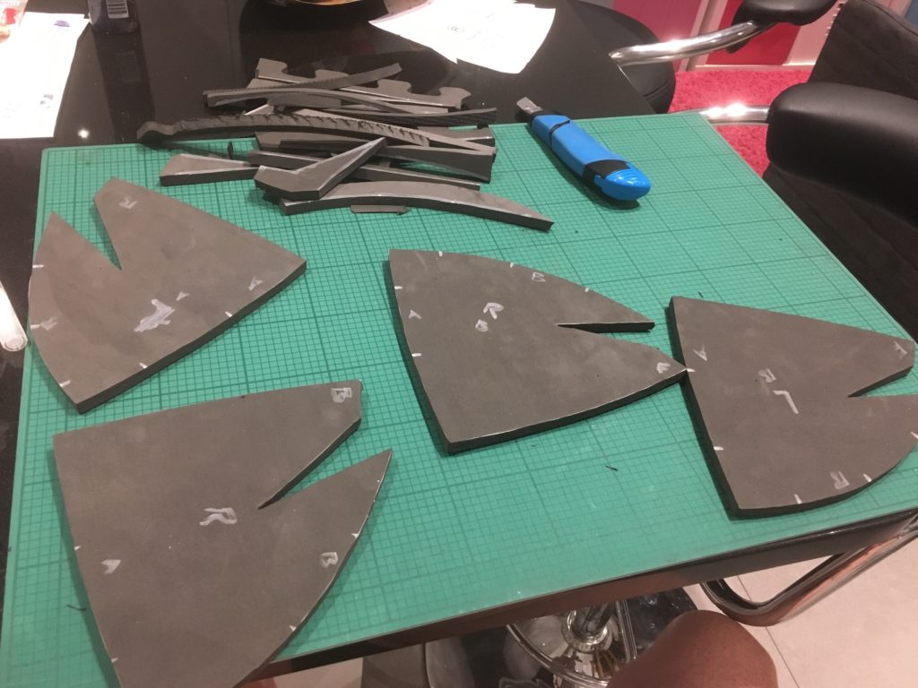 cutting out pieces to make a helmet from foam